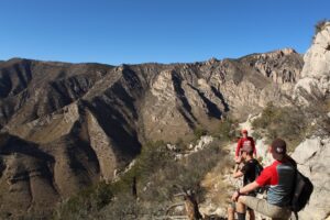 students climbing around a mountain top on a spring break trip in 2018