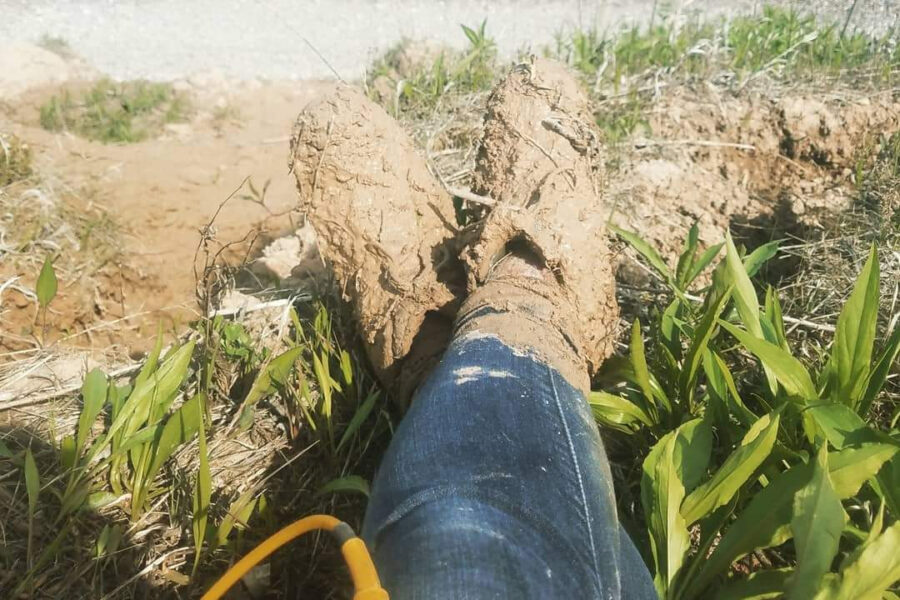 Photo from Chelsea Volpano's Twitter feed of her muddy boots after taking GPS readings on a Lake Michigan bluff while studing shoreline erosion.