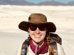 Emily in the desert with mountains in the background